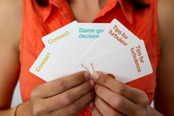 An attendees shows off the wellbeing cards she's chosen 