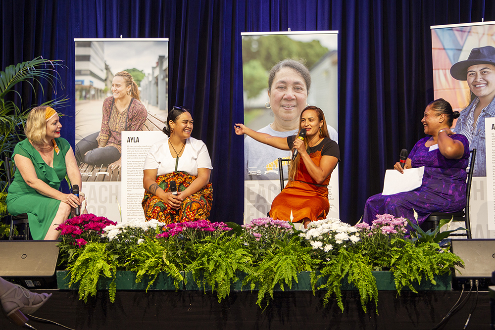 Ayla answers a question on stage as Minnie, Atarau, and Anita listen to her kōrero.