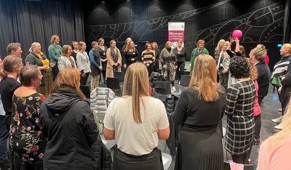 Attendees standing in circle for group activity