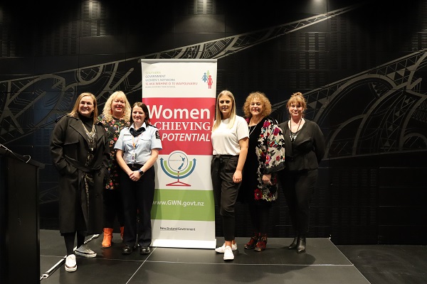 SGWN Committee Members standing in front of SGWN banner