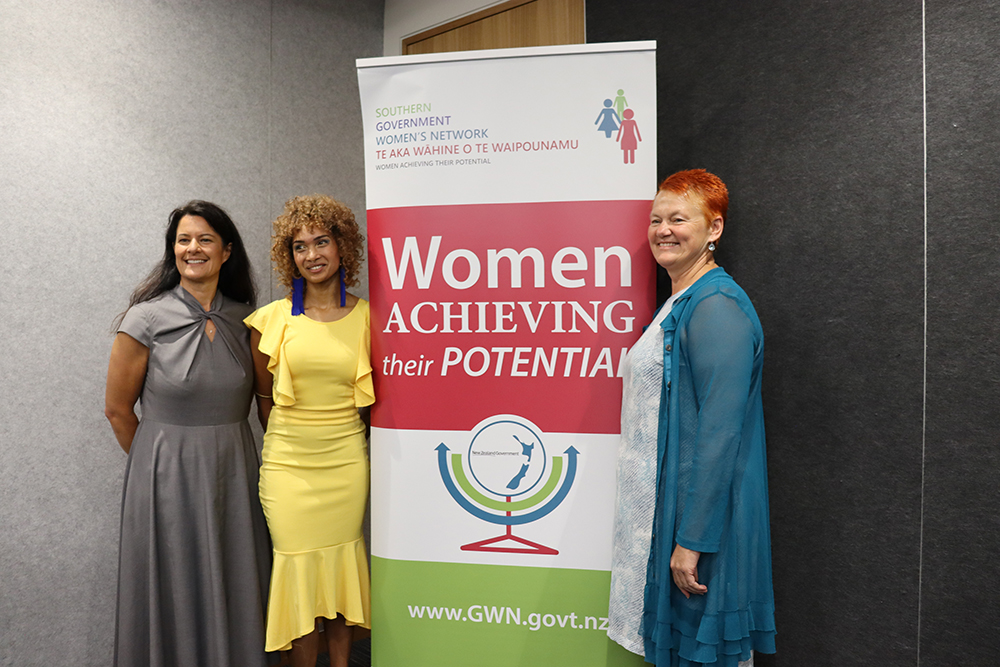 From left to right, Rachel Leota, Sophie-Claire Violette, and Helen Leahy pose around the GWN banner