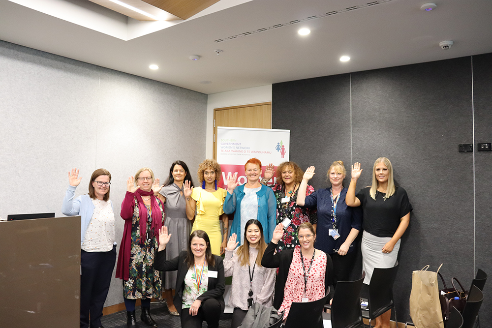 Speakers and members of the SGWN Committee strike the 'Choose to Challenge' pose