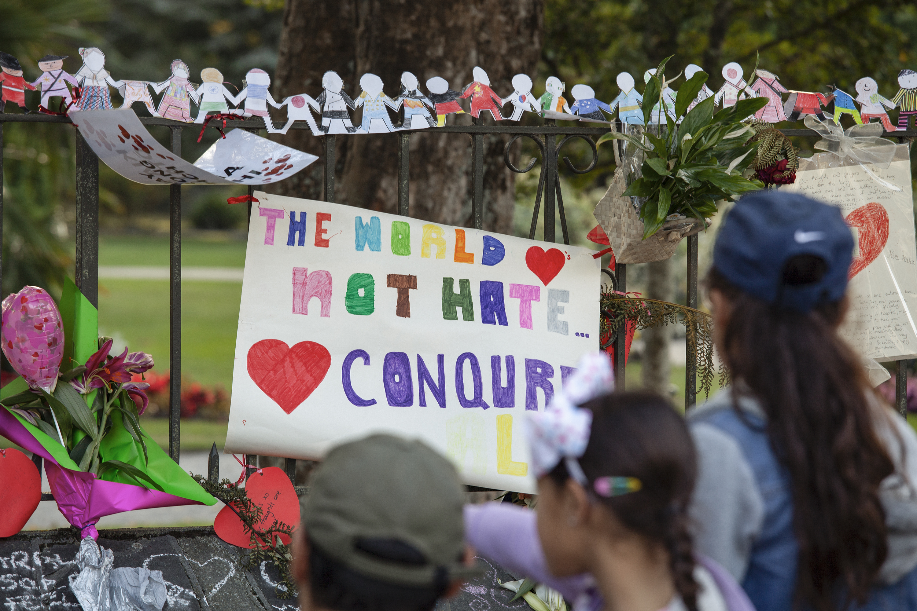 Child's banner on memorial site: 'The world [heart]'s not hate... [heart] conqurs (sic) ALL'